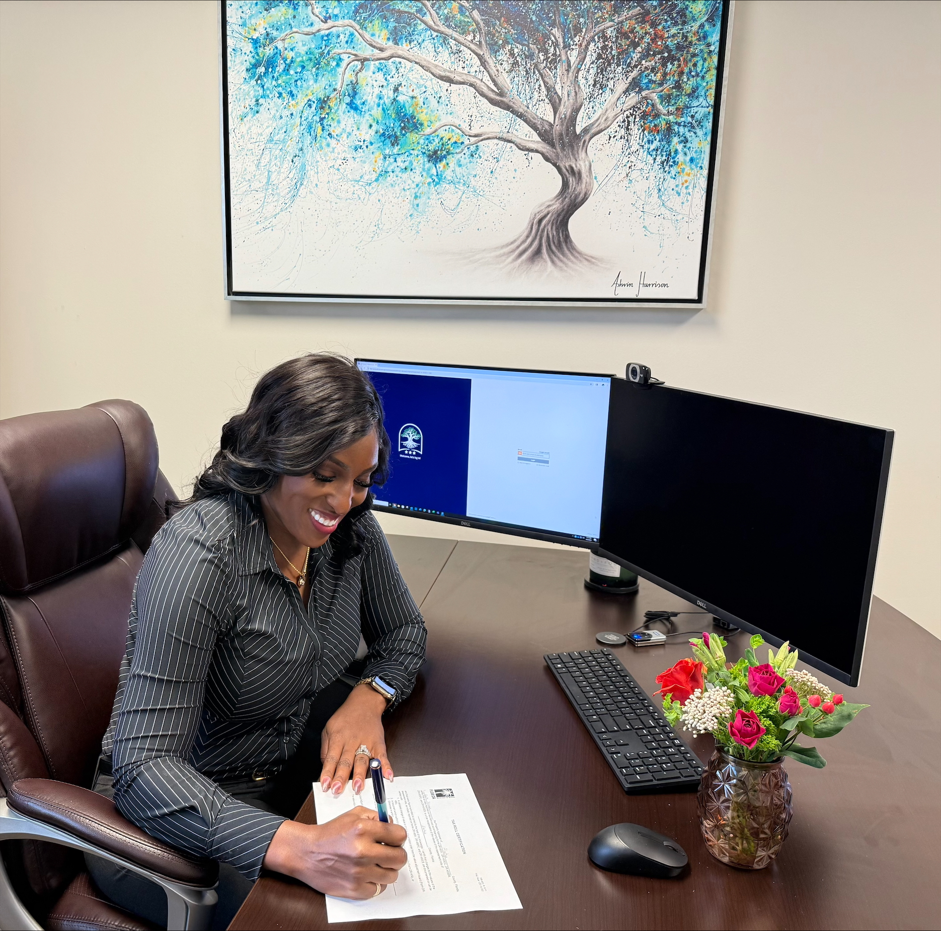 Property Appraiser's hand as she signs the Tax Roll Certification